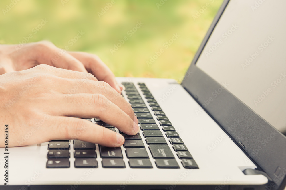 closeup hand using laptop computer outdoor closeup hand using laptop computer outdoor