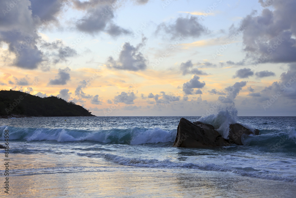 Waves at sunset on the beach of Anse Lazio