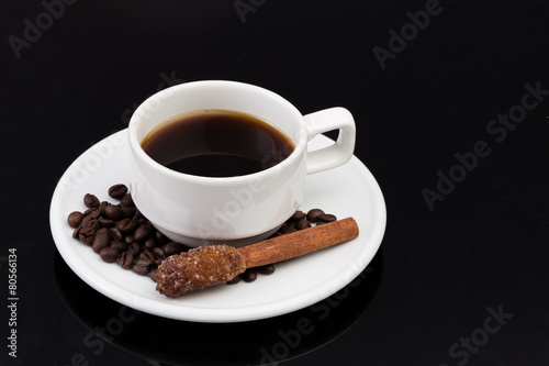 Cup of coffee with sugar stick  on black with clipping path