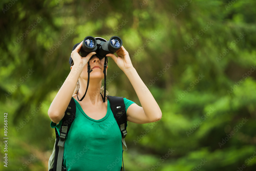 Hiker looking through binoculars Hiker looking through binoculars