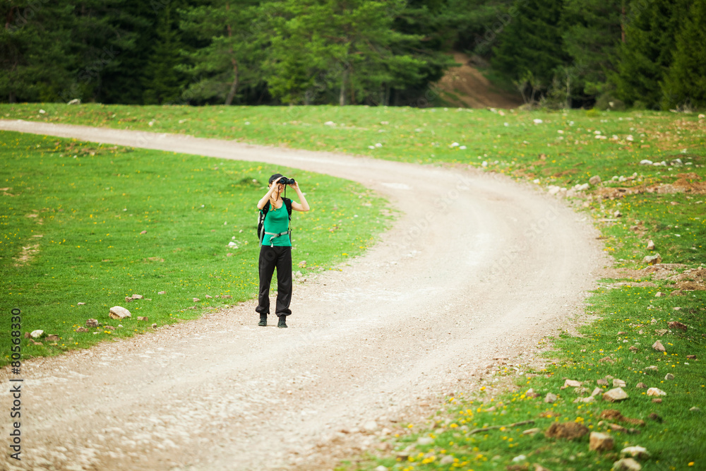 Hiker looking through binoculars