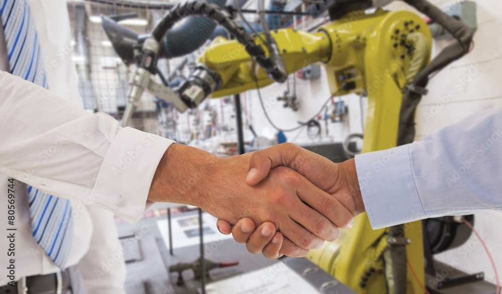 Composite image of close-up shot of a handshake in office Composite image of close-up shot of a handshake in office