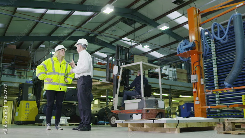 Team of busy warehouse workers lifting and moving empty pallets and boxes Team of busy warehouse workers lifting and moving empty pallets and boxes