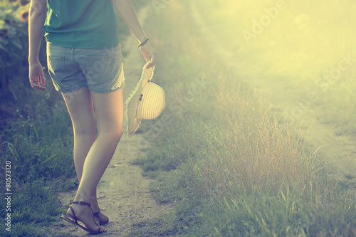 vVintage photo of summer sunset and woman walking photo