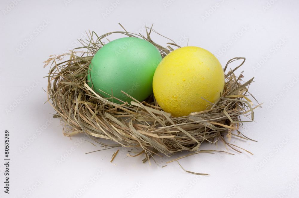 yellow and green easter eggs in nest isolated on white yellow and green easter eggs in nest isolated on white