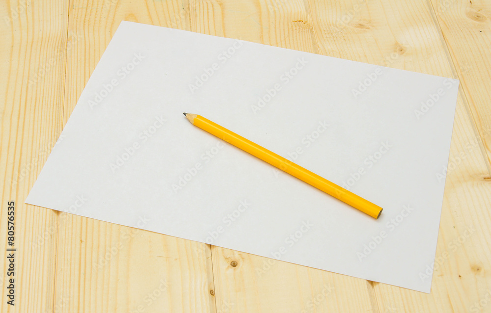 Paper with pencil on wooden background. Paper with pencil on wooden background.