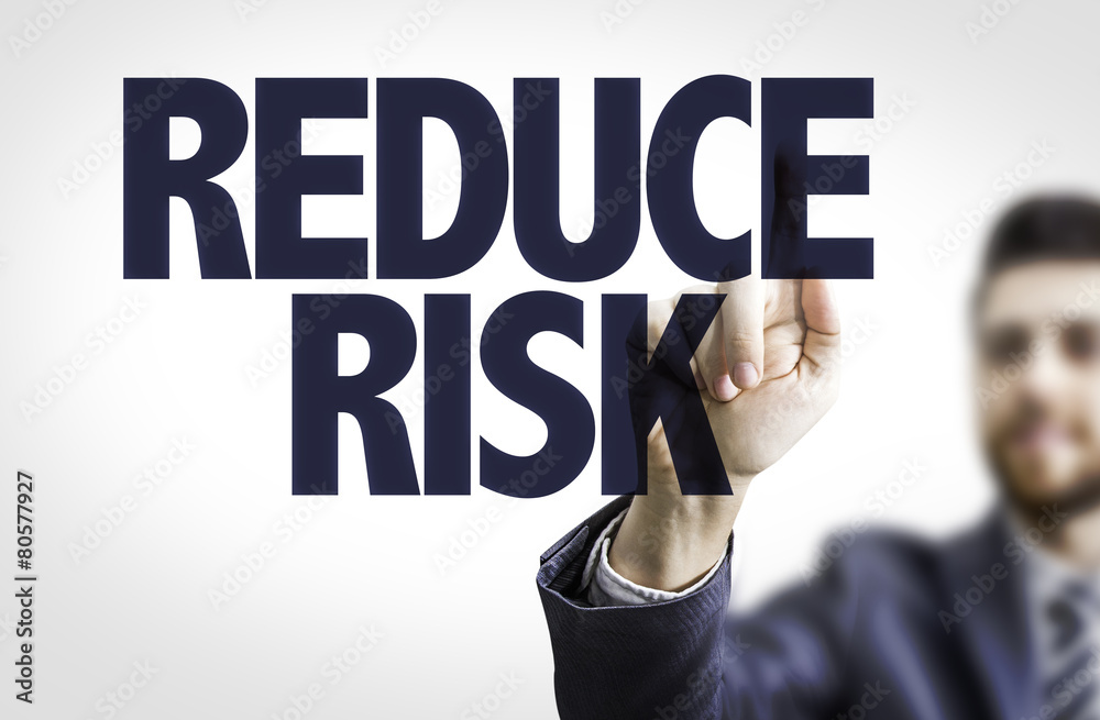 Business man pointing the text: Reduce Risk Business man pointing the text: Reduce Risk