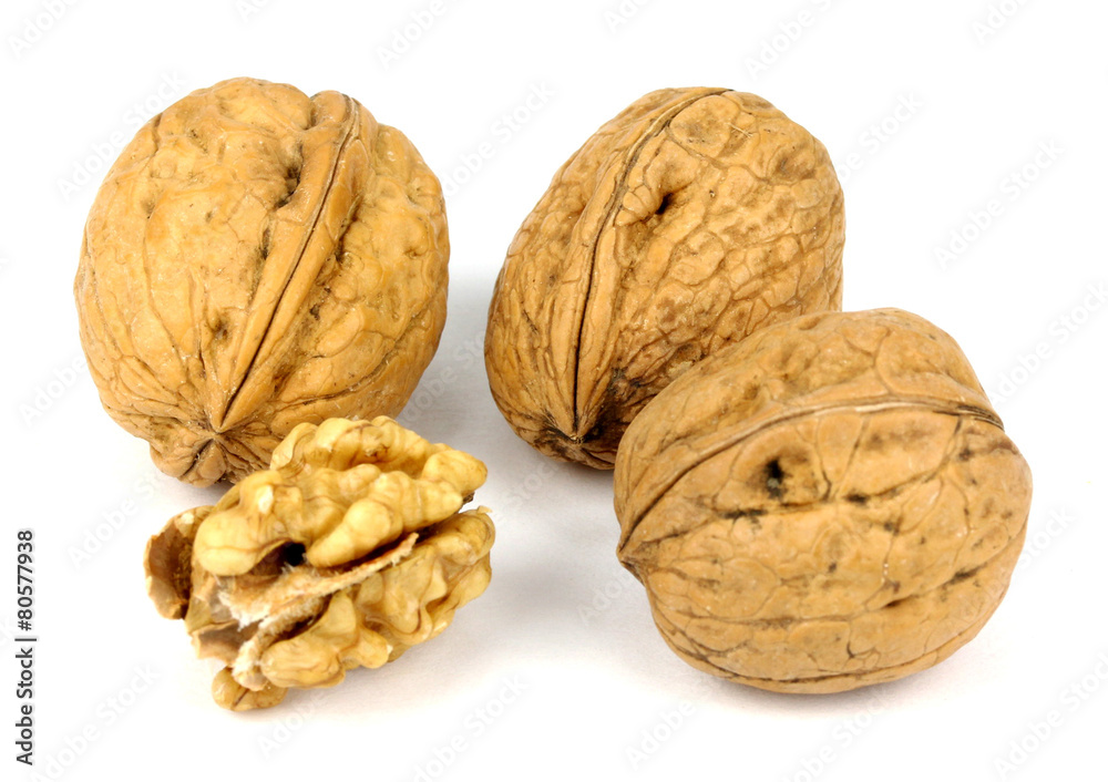 walnut and a cracked walnut isolated on the white background walnut and a cracked walnut isolated on the white background