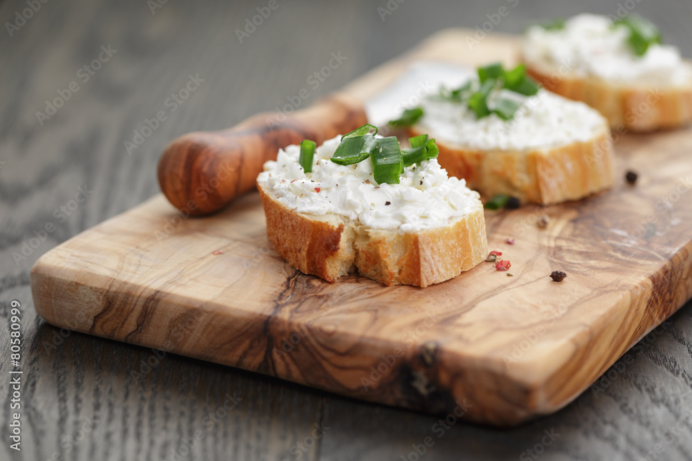 crunchy baguette slices with cream cheese and green onion on crunchy baguette slices with cream cheese and green onion on