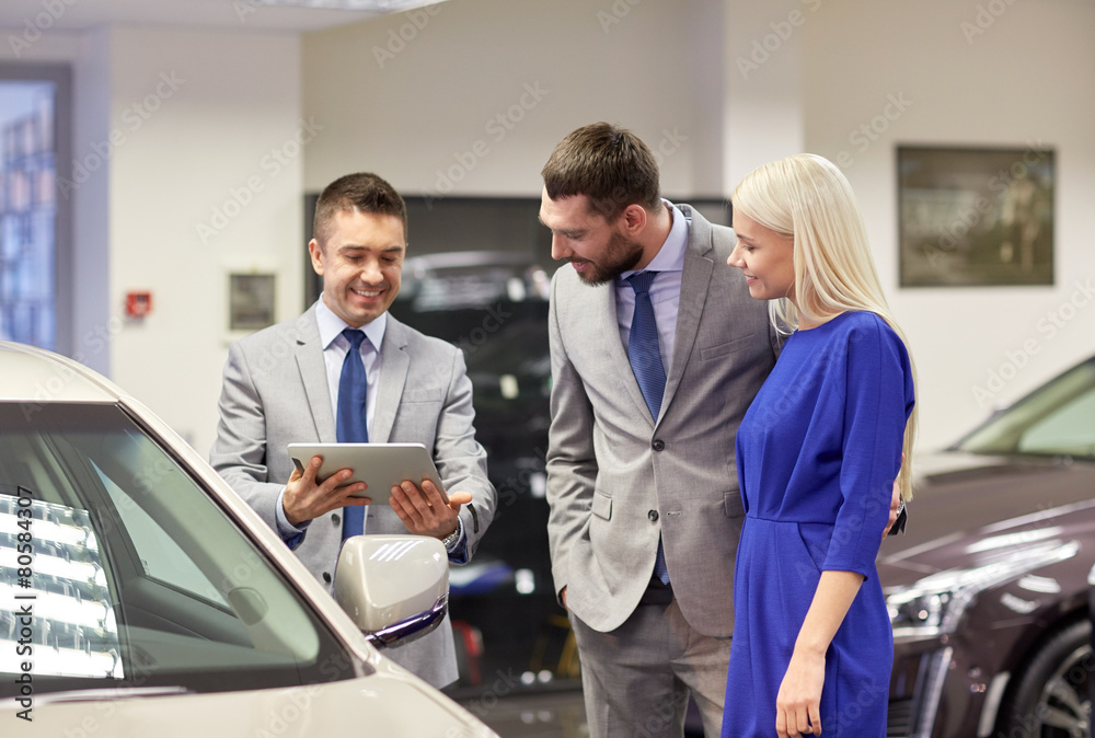 happy couple with car dealer in auto show or salon happy couple with car dealer in auto show or salon