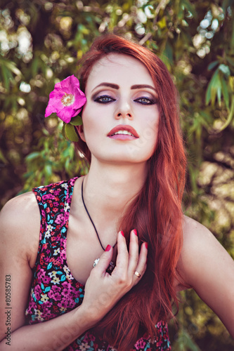 Beautiful girl with flower in her hair