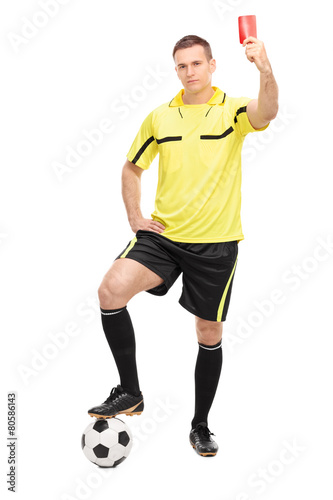 Strict football referee showing a red card