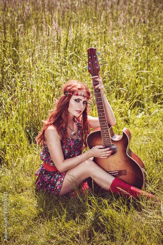 Romantic girl holding her guitar