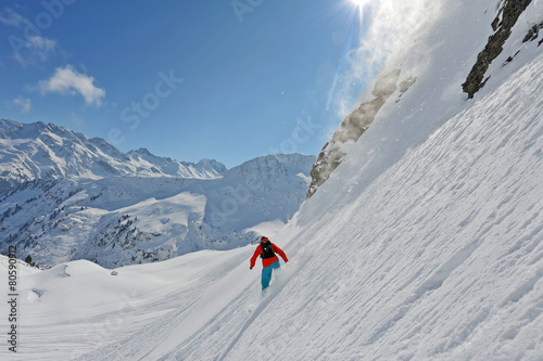 Snowboarder off-piste in powder terrain
