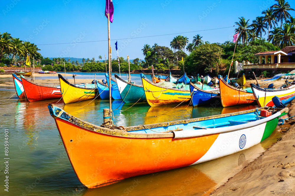 bright fishing boats on the river bank