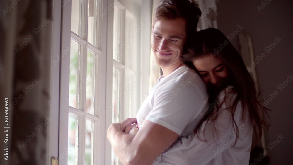 Couple hugging in their bedroom in the morning Couple hugging in their bedroom in the morning