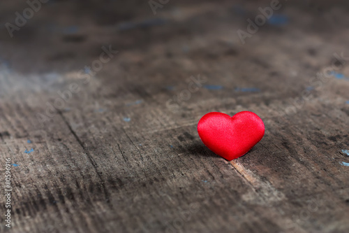 Red heart on a wooden table