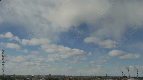 Timelapse floating clouds on a blue sky over the city 4K