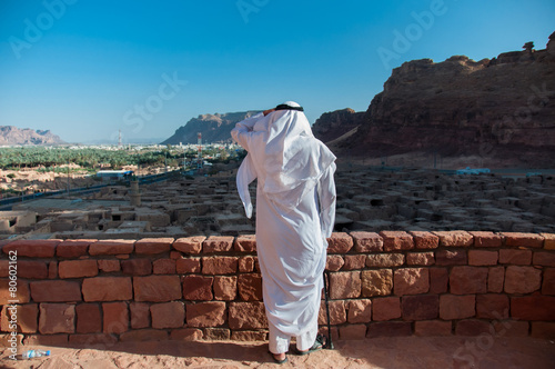 Saudian overlooking the old city of Al Ula, Saudi Arabia photo