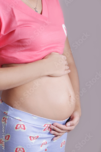 Wallpaper Mural Pregnant woman holding her belly Torontodigital.ca