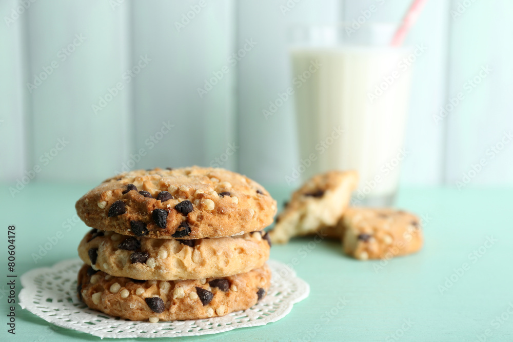 Tasty cookies and glass of milk on color wooden background Tasty cookies and glass of milk on color wooden background