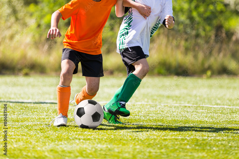 Football soccer game. Boys playing football match Football soccer game. Boys playing football match