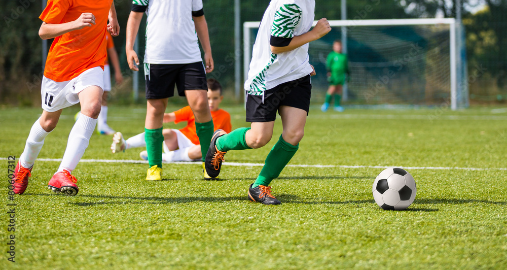 Football match for children. Boys playing football match Football match for children. Boys playing football match