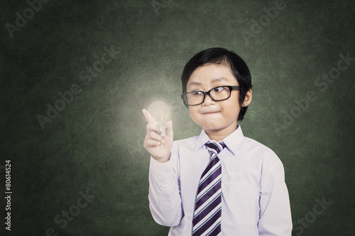 Young asian boy holds a light bulb