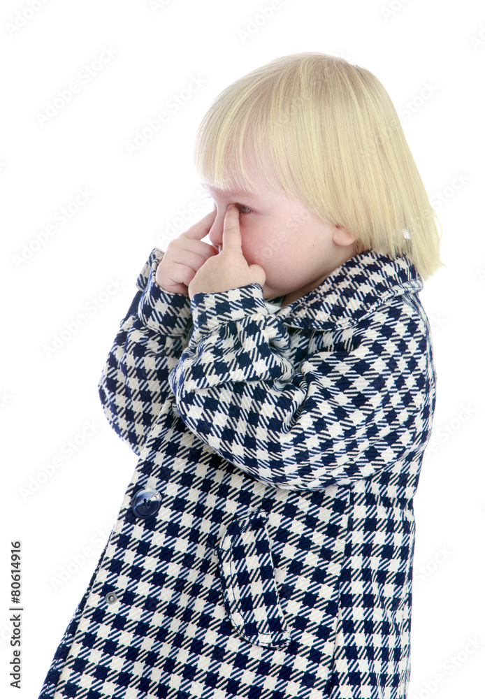 Caucasian little girl wipes her tears fingers. Caucasian little girl wipes her tears fingers.