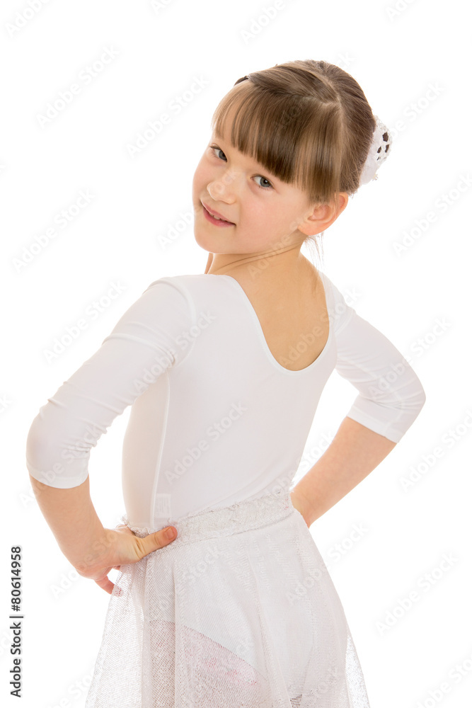 Girl in white gymnastic leotard looks over his shoulder Girl in white gymnastic leotard looks over his shoulder