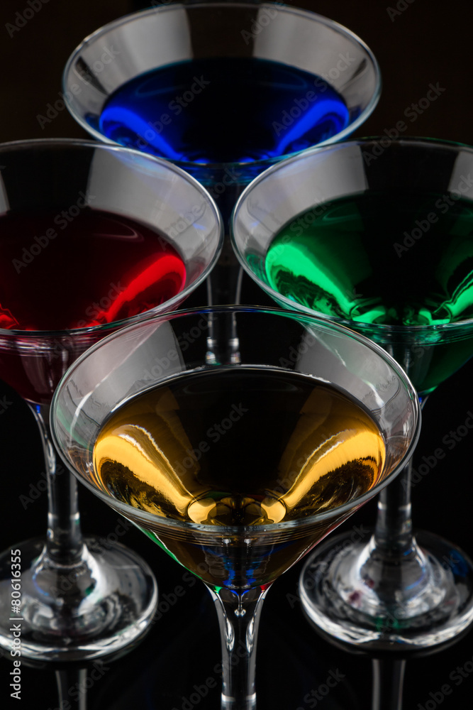 overhead shot of color cocktails in martini glasses