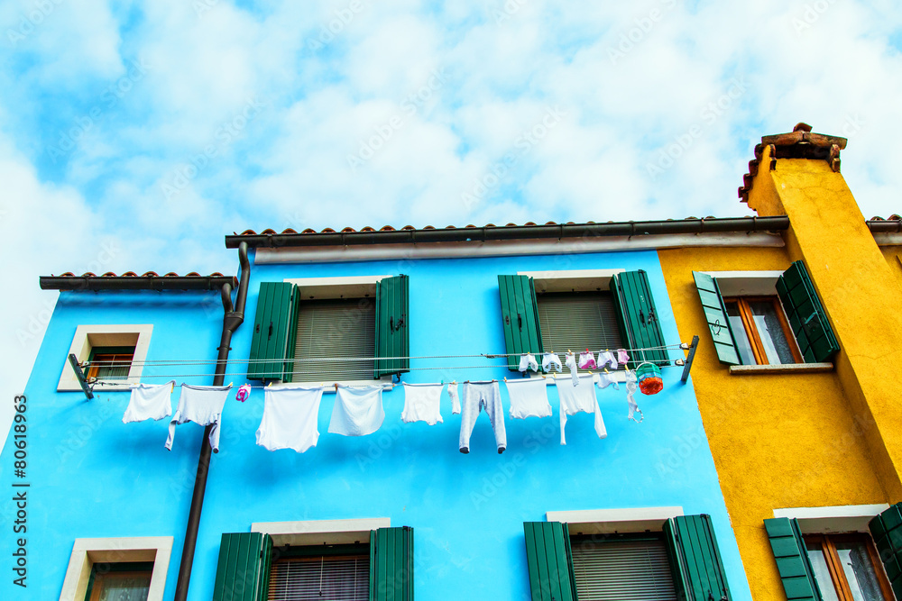 Colorful houses in Burano with the laundry drying on a wire