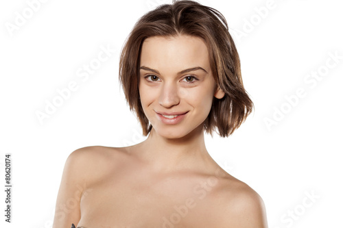 Happy young beautiful girl without make up on white background