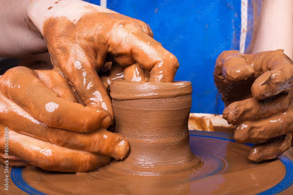 closeup of hands of potter teaching how make clay pot
