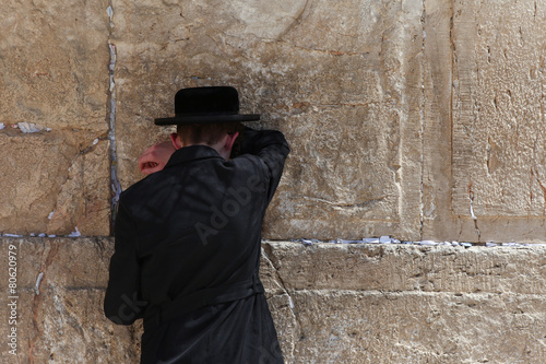 Orthodox Jewish man pray at the western wall - Jerusalem, Israel