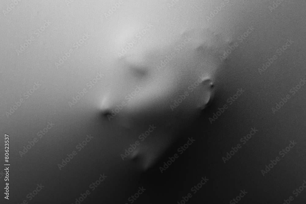 Obraz premium Screaming human face pressing through fabric as horror background