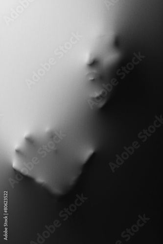 Canvas Print Screaming human face with hand pressing through fabric as horror background