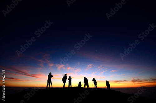 Silhouette of Hiker and Photographer with colorful sunrise