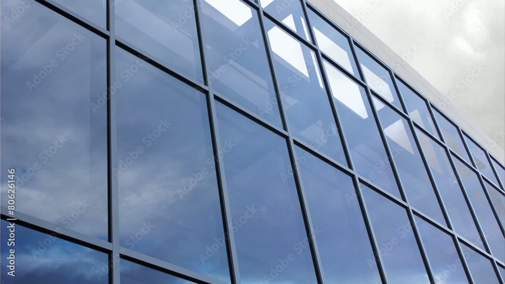 Glass facade with reflection of clouds Glass facade with reflection of clouds