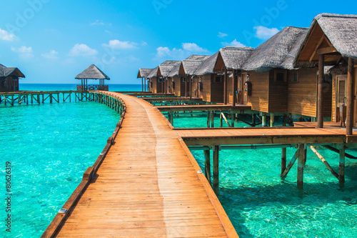Over water bungalows with steps into amazing green lagoon © theyok