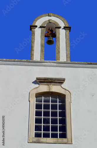 Querenca church window and bell tower photo