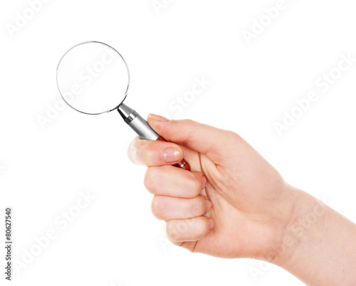 Female hand with magnifying glass isolated on white