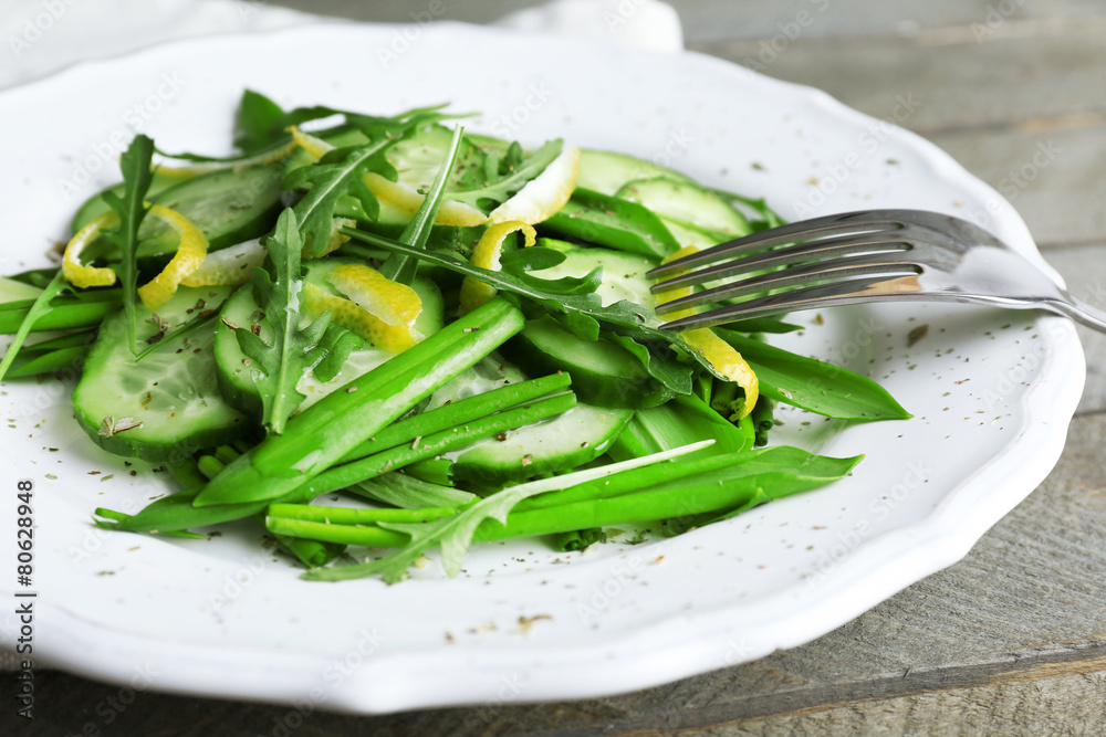 Green salad with cucumber, arugula and lemon peel