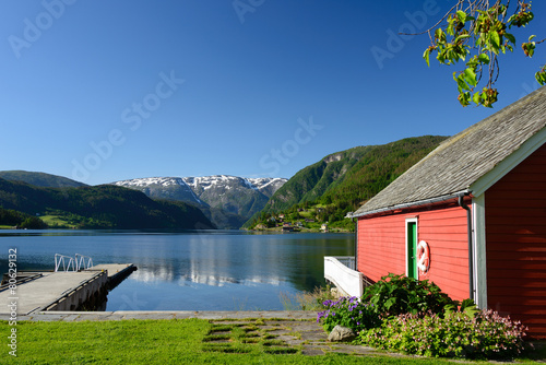 Print op canvas Fjord view with boathouse
