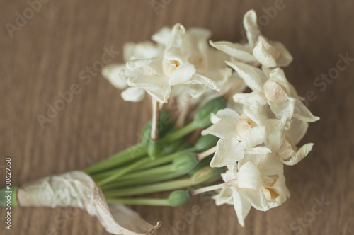 Dry narcissus flowers detail, on wooden background