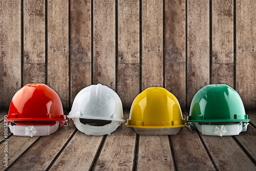 safety helmet and architect plant on wood background.