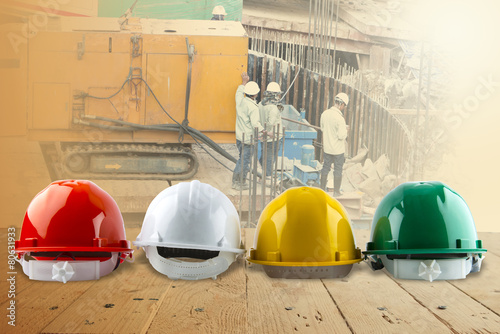 safety helmet and architect plant on wood table