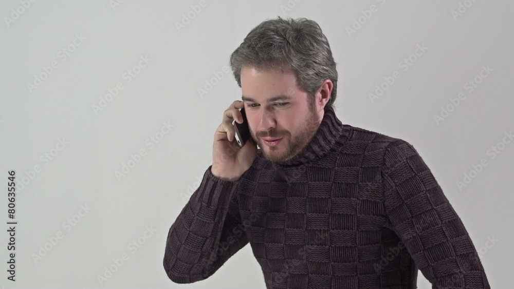 Man in sweater speaks on a mobile phone Man in sweater speaks on a mobile phone