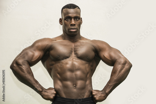 Handsome black male bodybuilder posing in studio