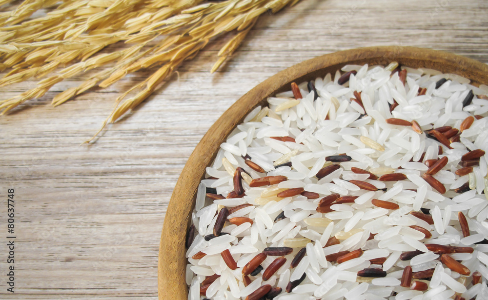 white and red rice on the wooden plate and rice plant